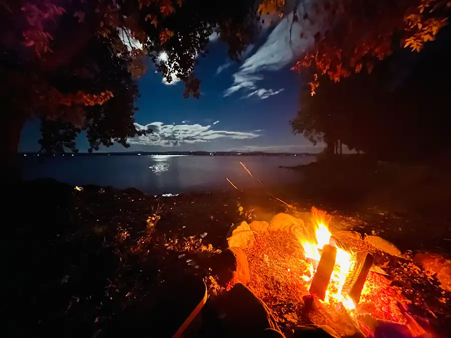 Lake at night with open campfire